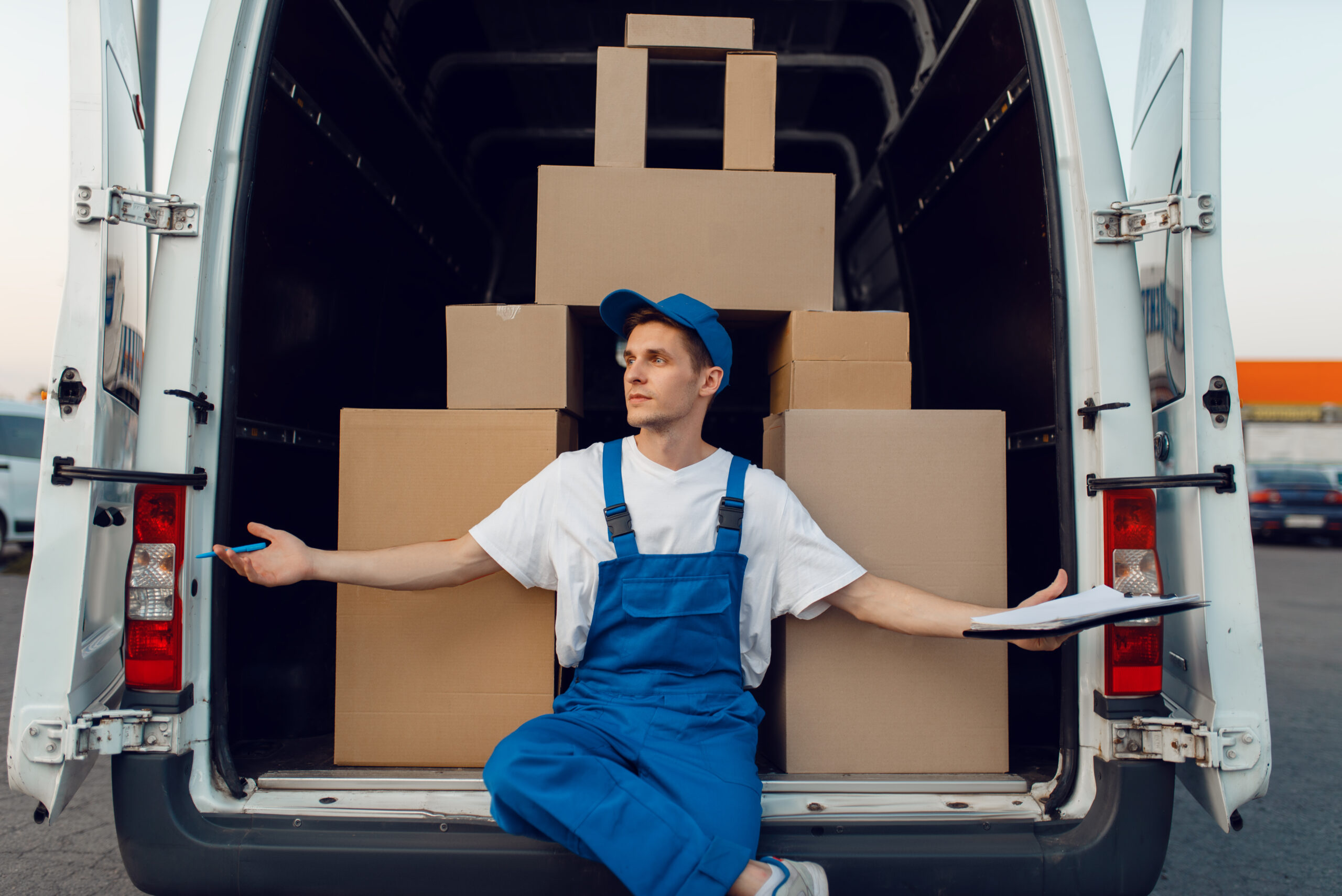 Deliveryman at the car, boxes in a pyramid shape